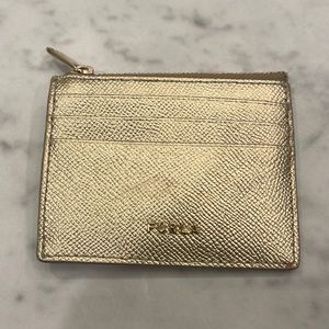 This is an all gold Furla card holder. Great quality.